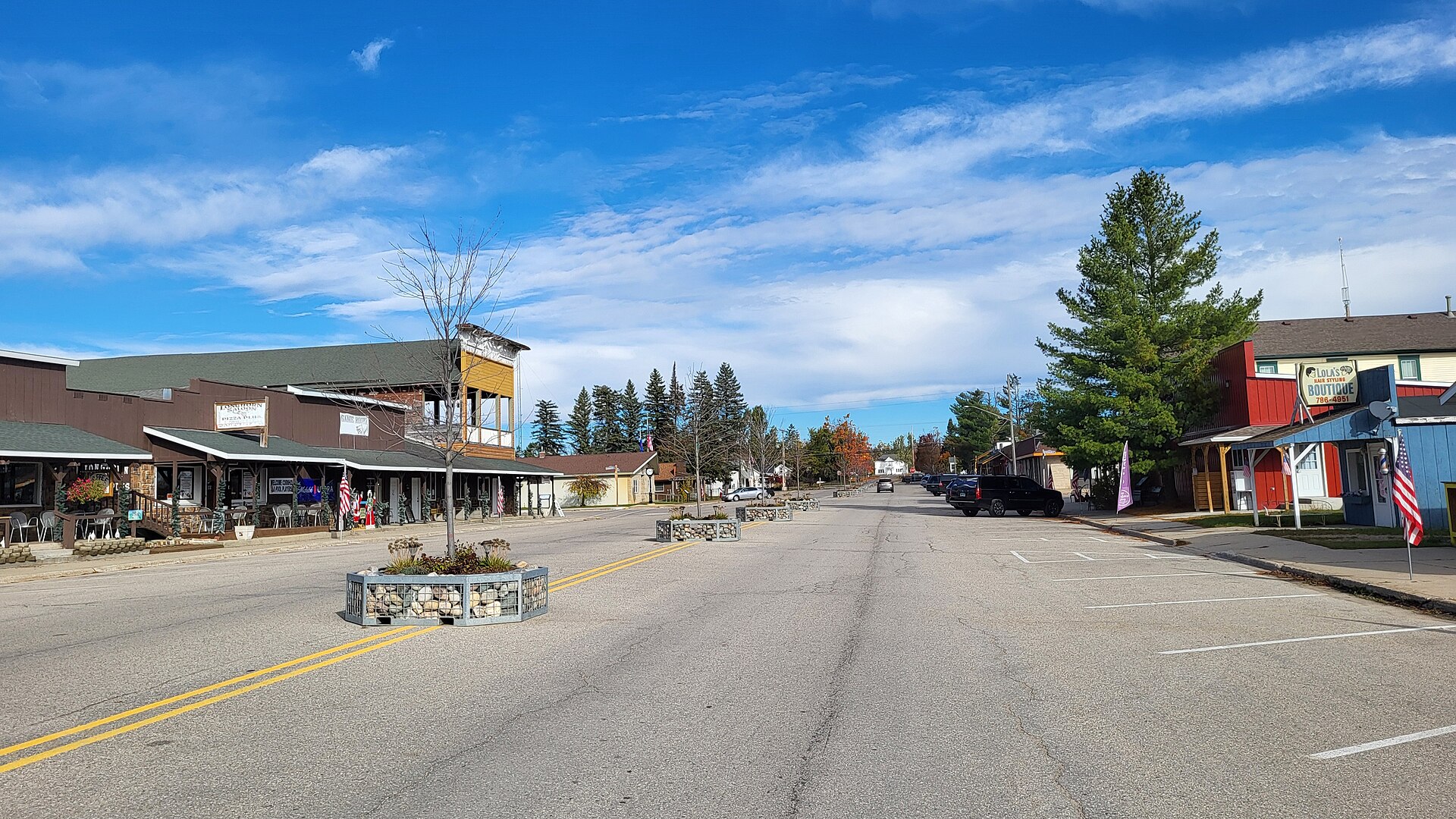 Downtown Lewiston, Michigan, under a blue October sky with fall color at the end of the main street