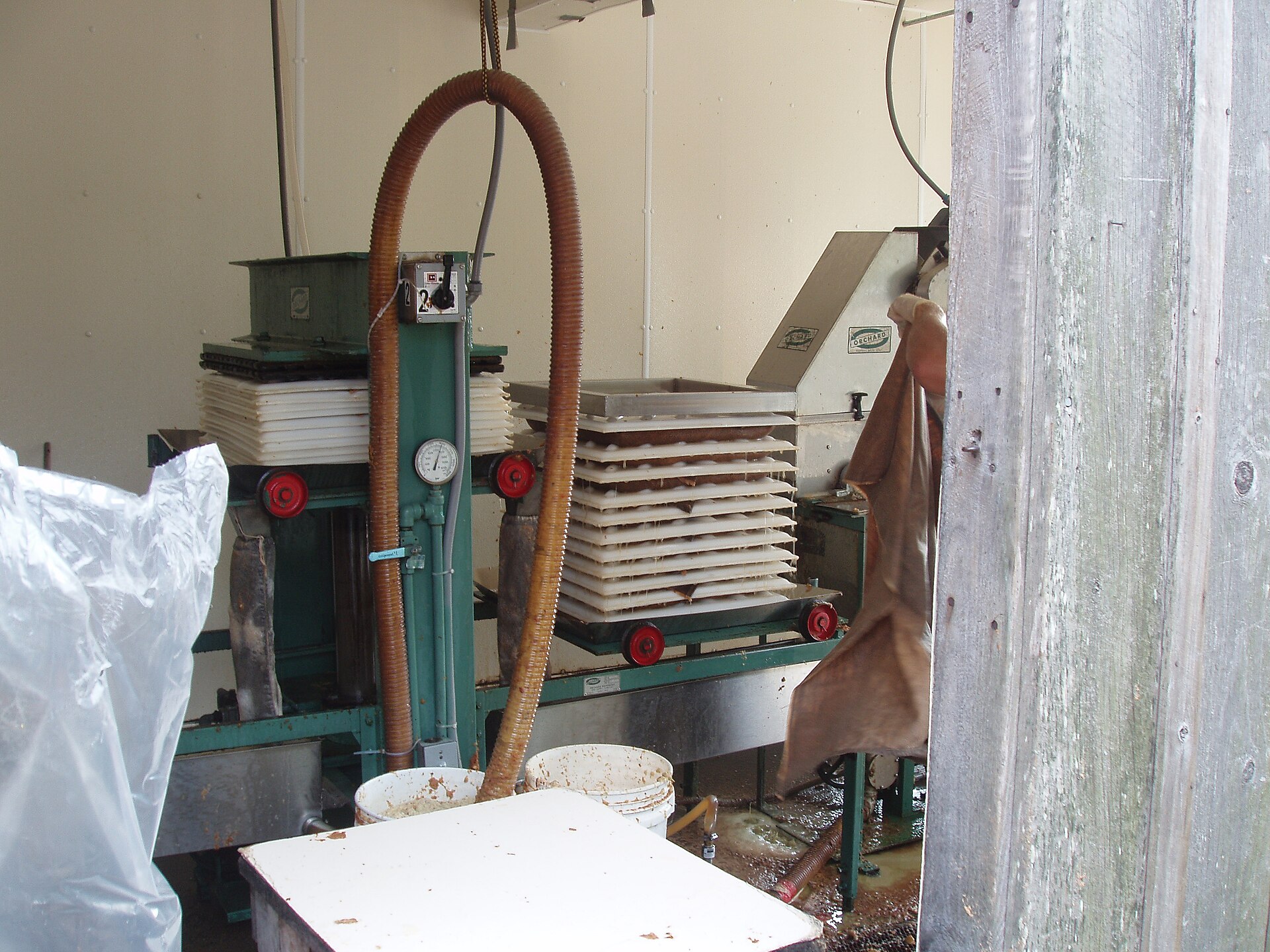 A traditional apple cider press extracting fresh juice from pressed apples